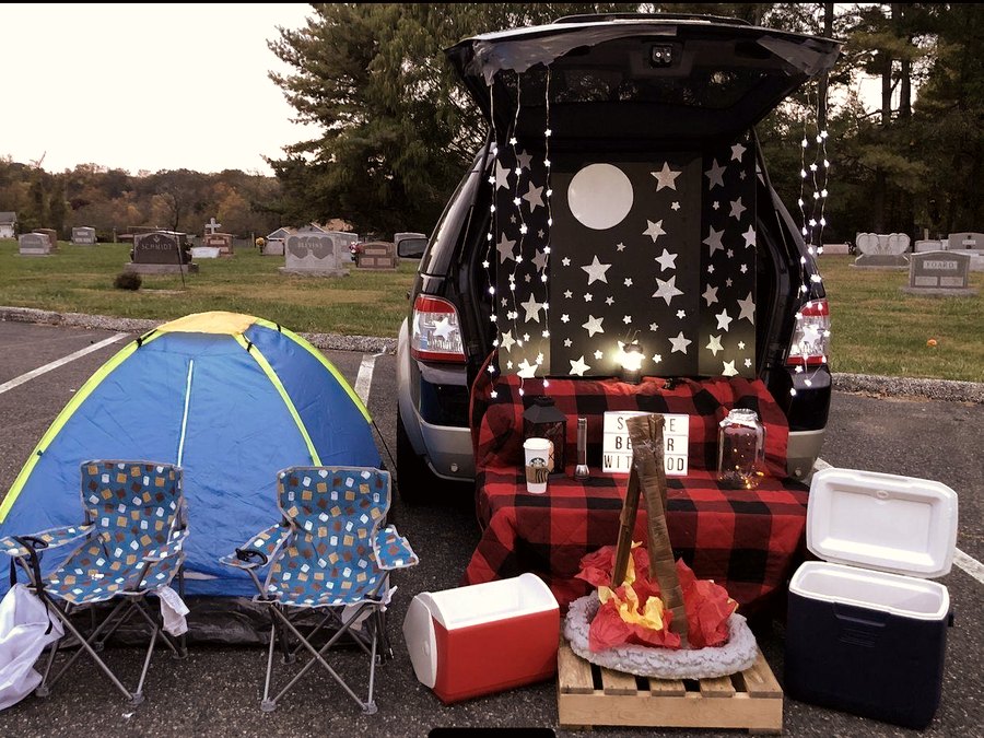 Camping themed trunk with tent, string lights, and campfire