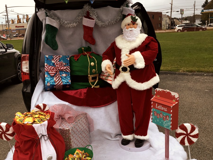 Christmas themed trunk with Santa, stockings, and wrapped gifts