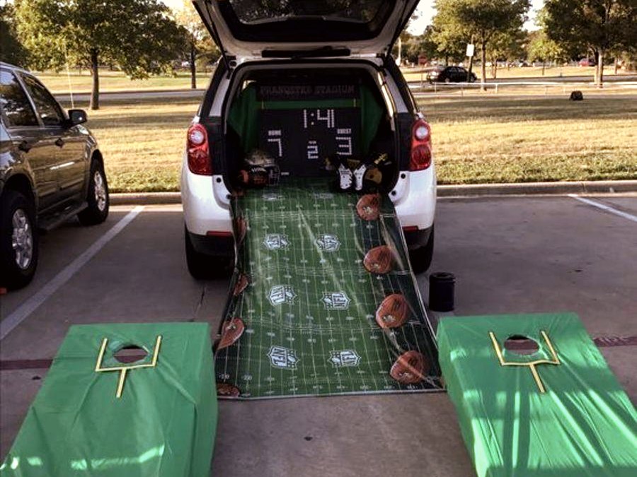 Sports tailgate themed trunk with football-field cornhole boards
